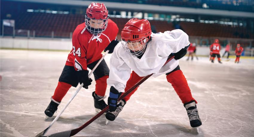 two young kids playing hockey