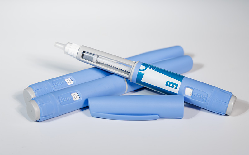 GLP-1 injectable medication pens with dosage labels on a white background.