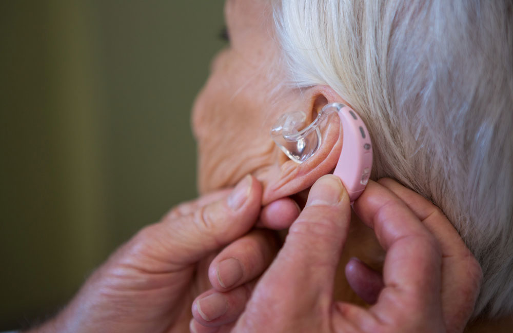 Woman being fitted with hearing aid