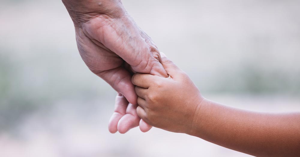 child and grandmother holding hands