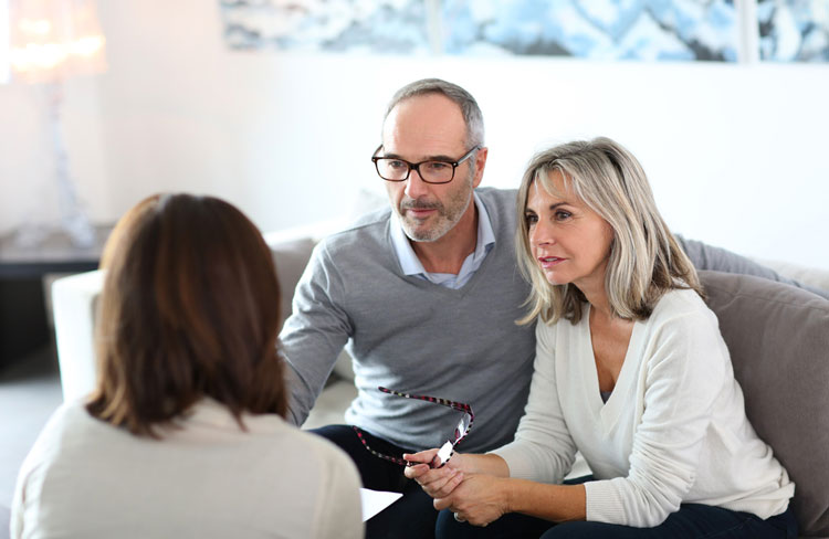 Couple speaking with financial planner