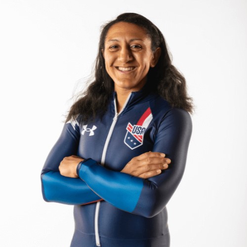 Elana Meyers Taylor, Team USA bobsled athlete, smiling with arms crossed in a navy blue USA uniform.