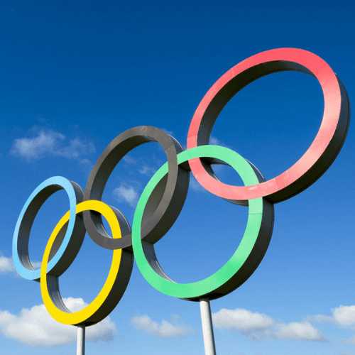 Image of the Olympic rings with a blue sky background